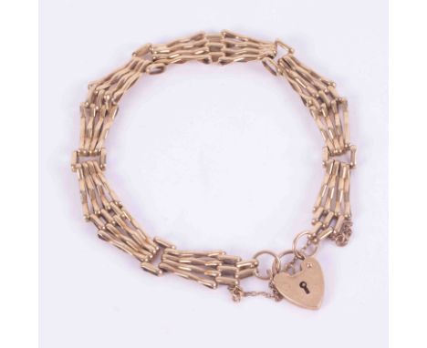 A 9ct yellow gold gate bracelet with heart padlock and safety chain, 10.13g.