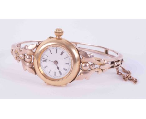 An antique 18ct &amp; 9ct yellow &amp; rose gold ornate bangle watch with push in clasp &amp; safety chain, (currently tickin