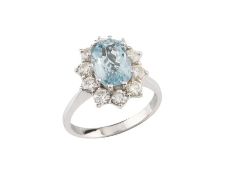 An aquamarine and diamond cluster ring, the oval mixed-cut aquamarine claw set within a border of round brilliant-cut diamond