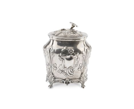 A late Victorian silver tea caddy, of shaped oval form, repoussé decorated with flowers and scrolling foliage, the hinged cov