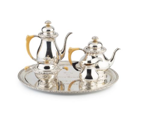 An early 20th century German silver four piece tea and coffee service on tray, of baluster form with florally decorated borde