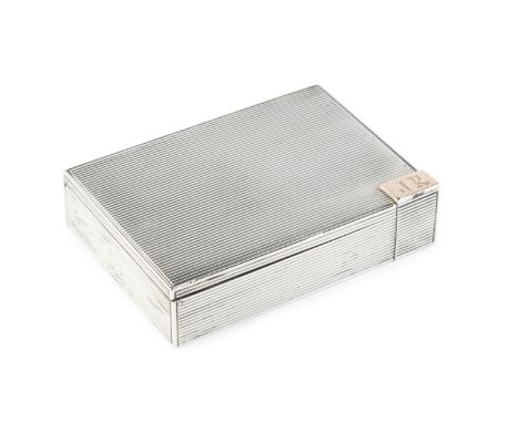 A Continental silver rectangular compact, with reeded decoration, opening to reveal a hinged reeded powder compartment and ha