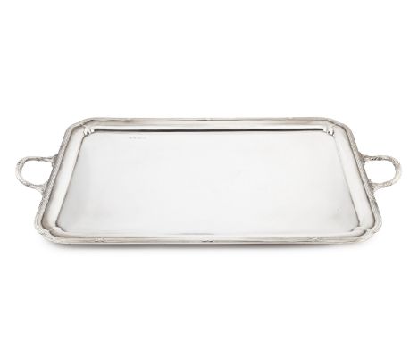 A George V silver twin handled tea tray, the reeded border with re-entrant corners, and strapwork handles, by Elkington &amp;