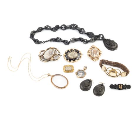 A collection of 19th century and later memorial jewellery, comprising two black enamel and hairwork panel brooches, each with