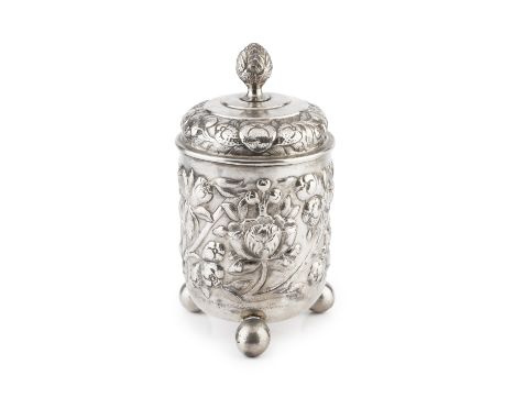 An 18th century Continental silver beaker and cover, embossed and engraved with fruit and stylised foliage, the cover with pi
