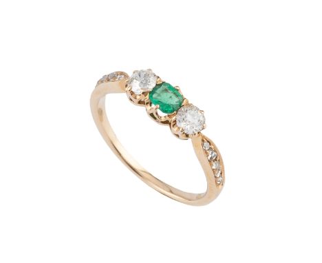 An emerald and diamond three stone ring, the cushion-shaped mixed-cut emerald claw set between two old brilliant-cut diamonds