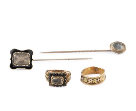 A small collection of memorial jewellery, comprising a stone set memorial ring, with plaited hairwork panel and floral decora