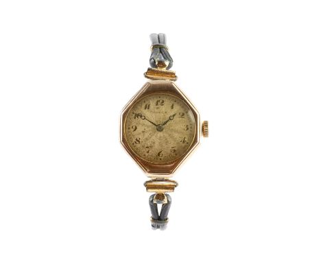 A lady's 9ct gold cased wristwatch by Rolex, the circular engine-turned dial with black Arabic numerals, to a jewelled manual