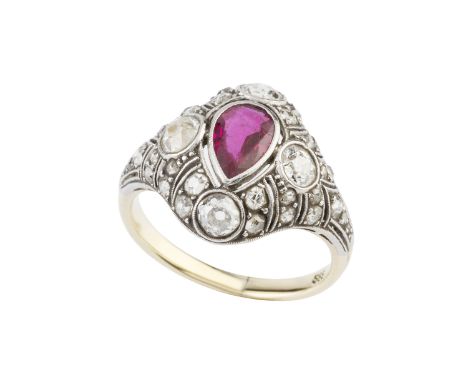 A ruby and diamond panel ring, the pear-shaped mixed-cut ruby collet set within a pierced and millegrained surround of gradua