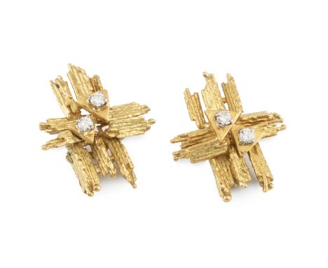 A pair of diamond set ear clips by Alan Martin Gard, of bark textured abstract cross design, each accented with a pair of rou
