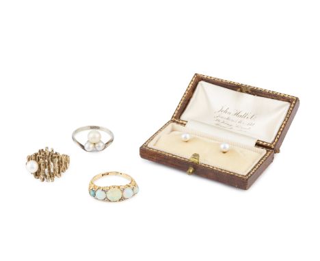 An opal and diamond half hoop ring, the graduated cabochon opals with rose-cut diamond points between, in scroll pierced moun