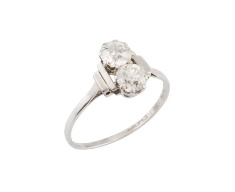 A diamond two stone ring, claw set with old brilliant-cut diamonds between stepped shoulders, white precious metal mounted, w