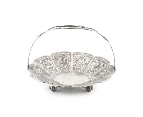 An early 20th century Chinese export silver swing handled fruit basket, pierce decorated and engraved with panels of dragons,
