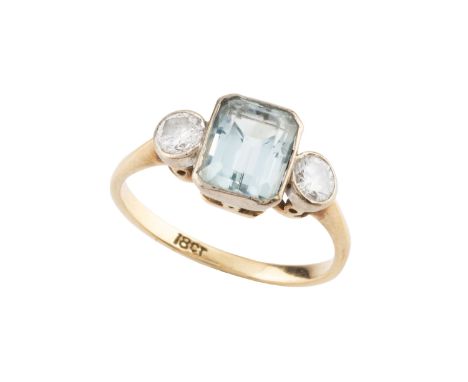 An aquamarine and diamond three stone ring, the rectangular step-cut aquamarine collet set between two round brilliant-cut di