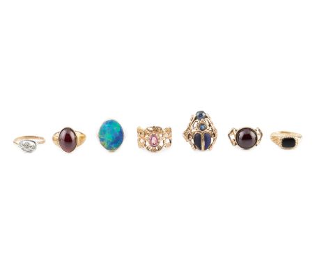 A collection of dress rings, comprising a black opal doublet ring, yellow precious metal mounted, a cabochon garnet single st