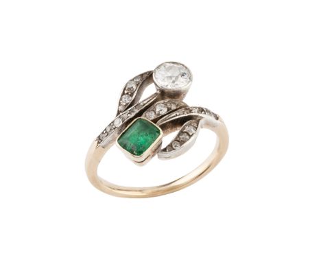 An emerald and diamond dress ring, of crossover design, obliquely collet set with an old brilliant-cut diamond and a rectangu
