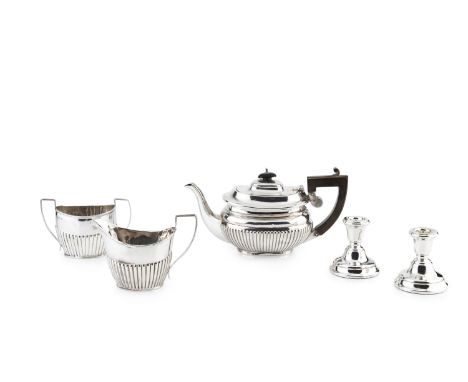 A silver matched three piece tea service, of half lobed oval form, the teapot with ebonised handle and knop by Nathan &amp; H