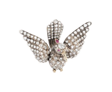 A late Victorian diamond and gem set bird brooch, modelled as a bird with outstretched wings and tail, set throughout with gr