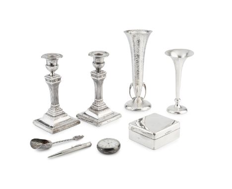 A pair of Edwardian silver candlesticks, of fluted and beaded form on weighted square bases by Walter Latham &amp; Son, Sheff