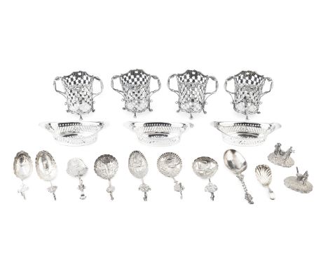 A set of four late 19th century Dutch silver twin handled cup holders, having pierced trellis and flowerhead sides, and handl
