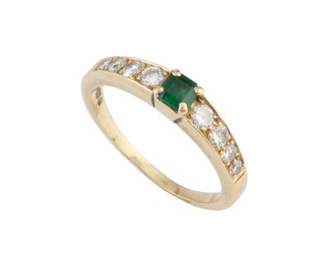 An emerald and diamond dress ring, the rectangular step-cut emerald claw set between tapered shoulders of round brilliant-cut