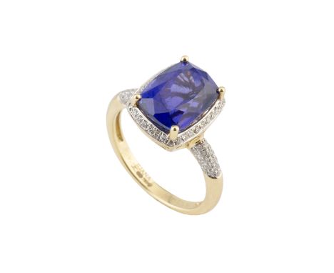 A tanzanite and diamond cluster ring, the cushion-shaped mixed-cut tanzanite claw set within a round brilliant-cut diamond bo