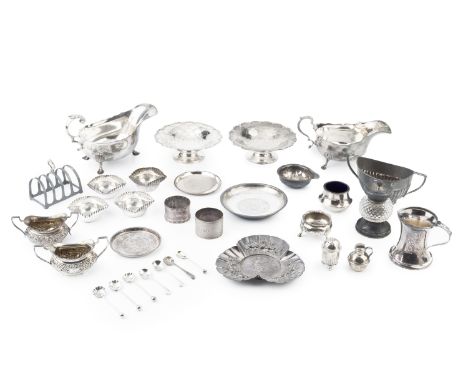A collection of silver, comprising two sauce boats, a pair of circular sweetmeat dishes, a five bar toast rack, a trefoil sha