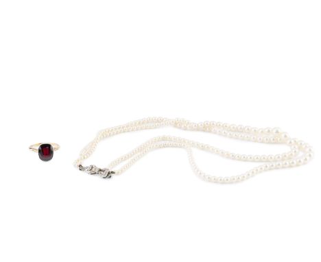 A garnet single stone ring, the cushion-shaped mixed-cut garnet in millegrain collet setting, two colour precious metal mount