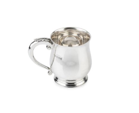 An Edward VIII silver pint mug, of plain slightly baluster form, the scroll handle with stylised leaf capping by Henry Hodson