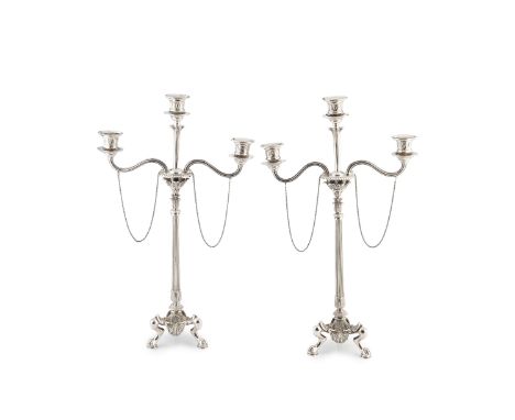 A pair of mid 19th century silver plated three-light candelabra, each having detachable branches and central nozzle, on acant
