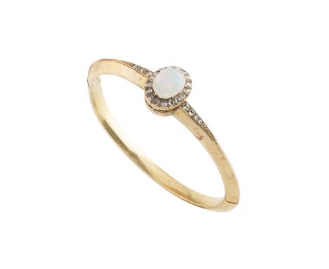 An opal and diamond set bangle, of hinged oval hollow form, centred with an oval cabochon opal and rose-cut diamond cluster, 