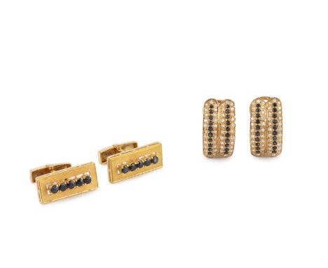 A pair of sapphire set cufflinks, each textured rectangular panel centred with a line of circular mixed-cut sapphires, on hin