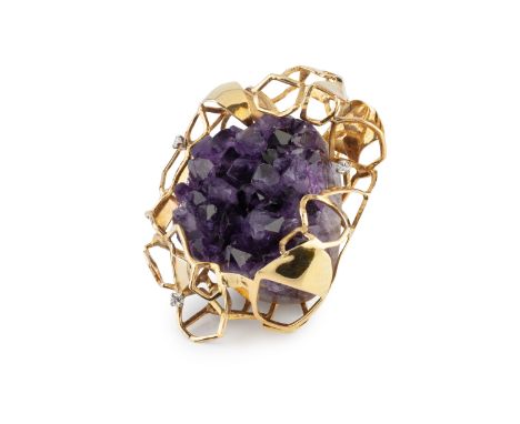 An amethyst and diamond panel brooch by Hooper Bolton, designed as an amethyst geode encased by an 18ct gold mount of abstrac