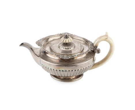 A George IV silver teapot, with gadrooned and foliate cast border, part lobed body, and ivory handle and knop, by William Ele