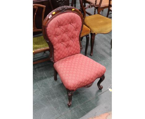 Victorian button back chair upholstered in red patterned material 