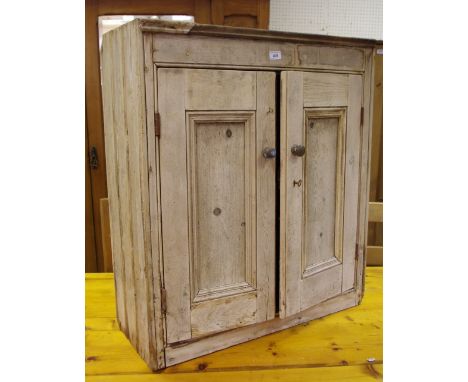 A Victorian rustic pine side cupboard, two panel doors enclosing shelving, 86cm high x 78cm wide x 29cm deep