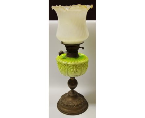 A Victorian Art Nouveau oil lamp, milk glass reservoir in tones of green, fluted white milk glass shade, brass base