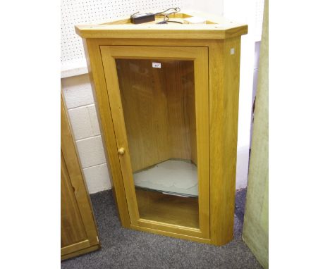 A modern light oak corner cabinet