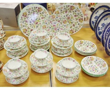 A Minton Haddon Hall pattern dinner service for six with platter; a tea set for twelve; six side plates; milk and sugar