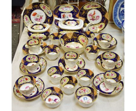 A 19th century boat shaped tea service, decorated with peonies and flowers, yellow borders, cobalt blue ground, c.1860