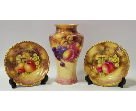 A Royal Worcester baluster shaped vase painted with peaches and grapes on a mossy ground, signed J.Smith, printed 2195 to bas