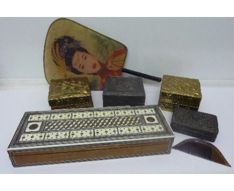 A Japanese comb, a Chinese face screen, an ivory inlaid games box, a pair of brass boxes decorated with ships and two other b