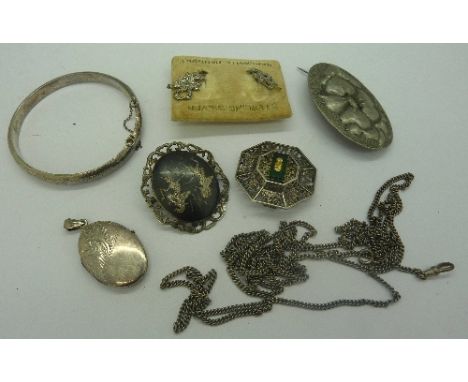 A silver pendant, locket, bangle, brooch, etc.