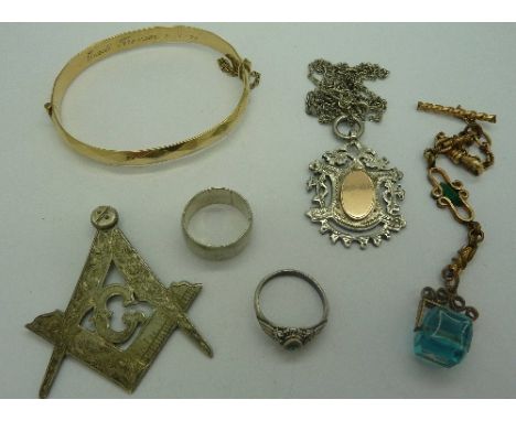 A 9ct gold metal core bangle, a metal chain and fob, two silver rings, a silver fob and chain and a silver Masonic fob