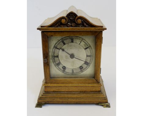 A late 19thC Architectural cased mahogany bracket clock, silvered dial beneath foliate scroll arched top case, glazed front d