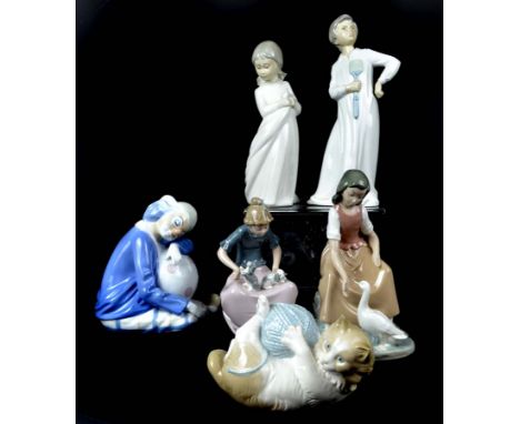 Nao by Lladro - porcelain figures, comprising boy with fly swatter; girl with puppies; girl holding her night dress; girl fee