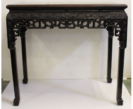 An attractive medium size late 19thC Chinese carved hardwood altar table, with pinkish inset marble top, ornate scroll and ke