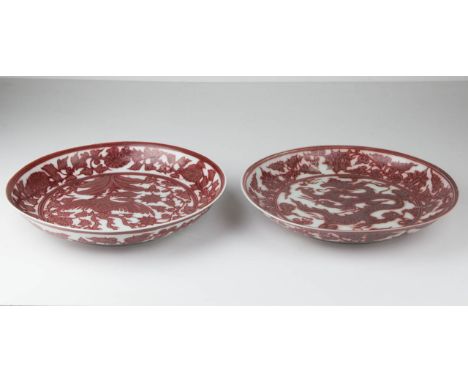 Two Chinese porcelain underglaze red decorated saucer dishes, decorated in Ming style with a scaly dragon; and a ho ho bird, 