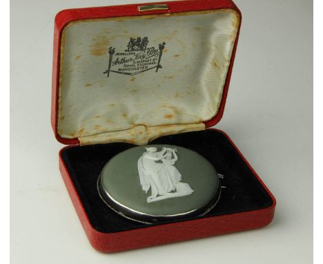 A large vintage Wedgwood green Jasperware white metal mounted brooch,  sprigged with a classical maiden playing a lyre, c1920
