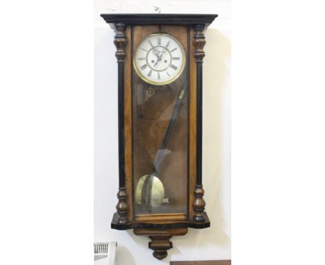 A Vienna regulator wall clock, in mahogany and ebonised finish, the white enamel dial within a brass frame, the case flanked 